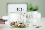 Getty Images 401k savings jar tipped over half empty