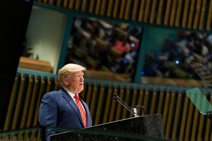 Donald Trump speaking at a podium.